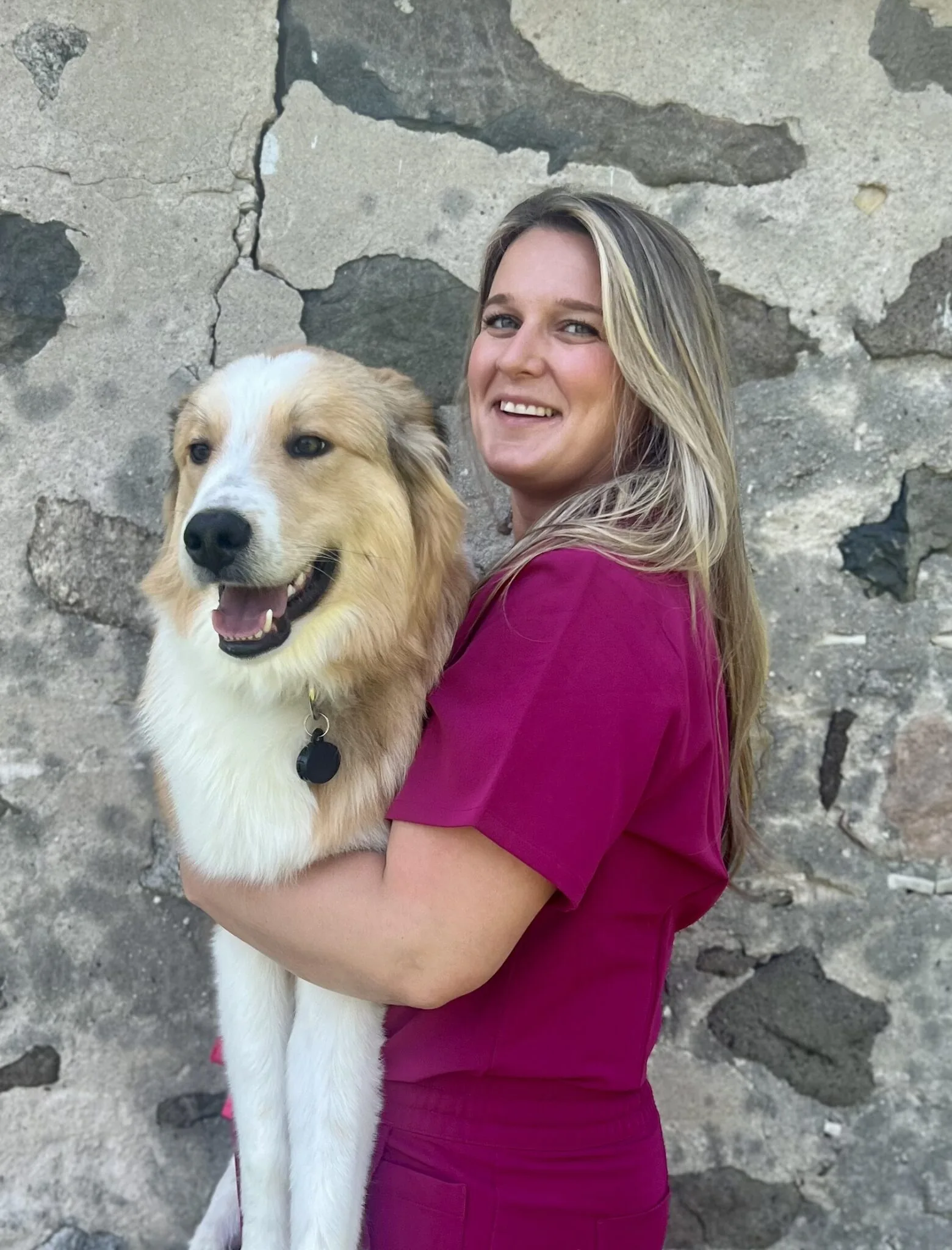 dr-lane dr lane in red scrubs holding a great pyrenees dog